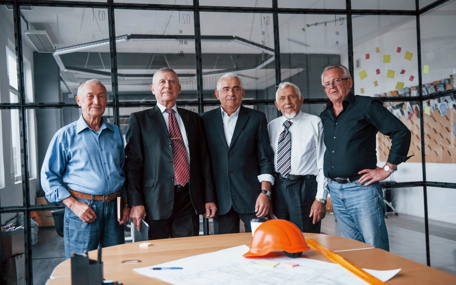 aged-team-of-elderly-businessman-architects-stands-2021-08-28-22-30-33-utc