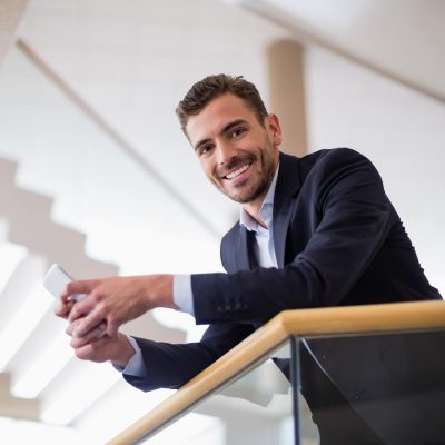 businessman-holding-mobile-phone-2021-08-28-18-10-37-utc