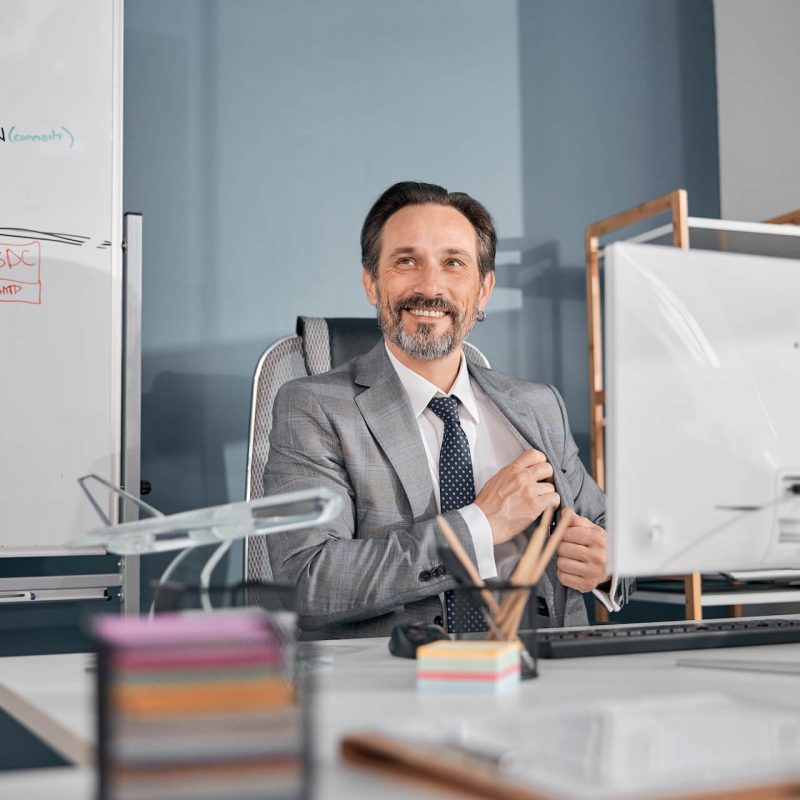 cheerful-businessman-in-gray-suit-working-in-moder-2021-09-03-14-19-38-utc